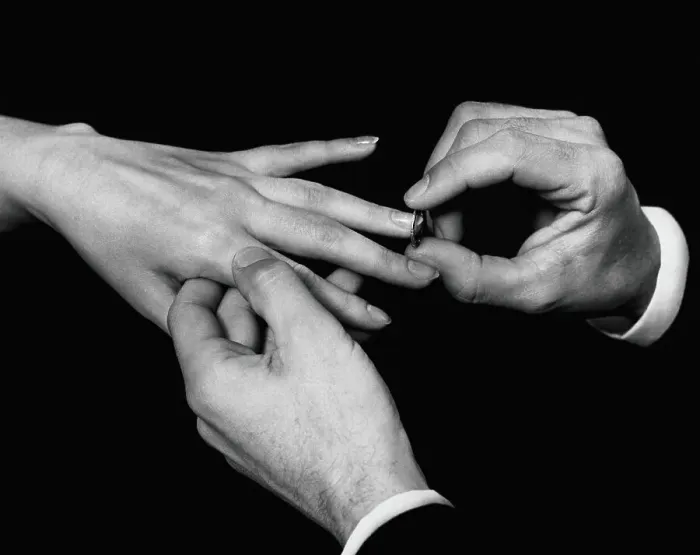 Framed Print : Man's hand putting ring on woman's finger Framed Print : Man's hand putting ring on woman's finger