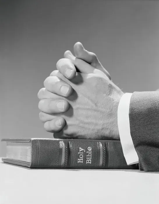 Framed Print : Man's hands resting on top of holy bible, in prayer
