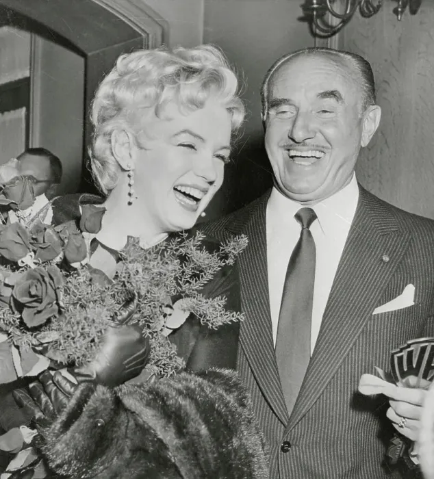 Framed Print : Marilyn Monroe Receiving Flowers From Jack Warner