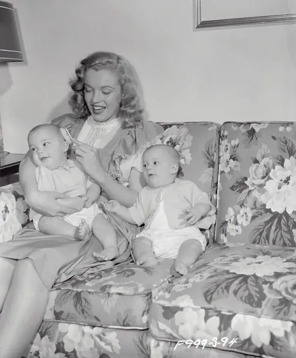 Framed Print : Marilyn Monroe Sitting on Couch with Babies Framed Print : Marilyn Monroe Sitting on Couch with Babies