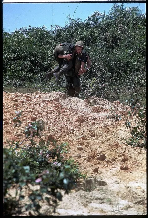 Framed Print : Marine Carrying Soldier to Safety Framed Print : Marine Carrying Soldier to Safety