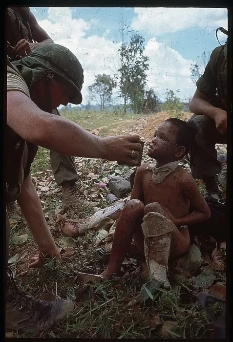Framed Print : US Marine Helping a Vietnamese Boy Framed Print : US Marine Helping a Vietnamese Boy