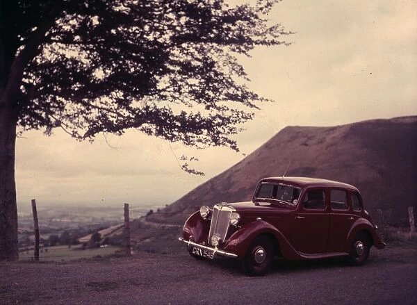 A maroon Triumph Car at a preview of the Motor Show 1952