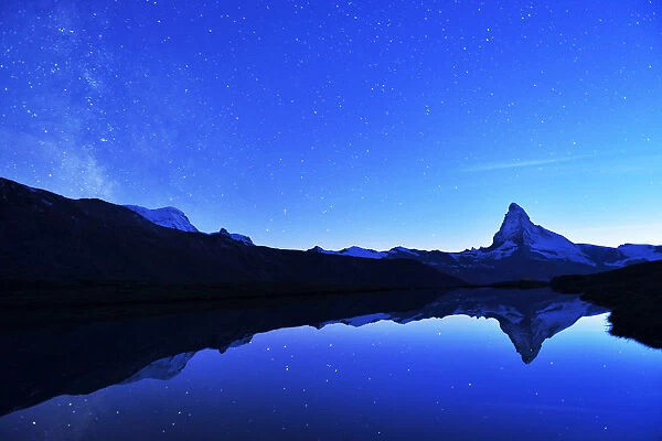 Matterhorn with Milky Way reflected in lake Stellisee, at night, Valais Alps, Canton of Valais, Zermatt, Switzerland