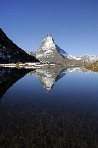 Matterhorn reflected in Lake Riffelsee, Zermatt, Valais, Switzerland, Europe
