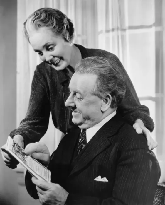 Framed Print : Mature couple looking at folder (B&W) Framed Print : Mature couple looking at folder (B&W)
