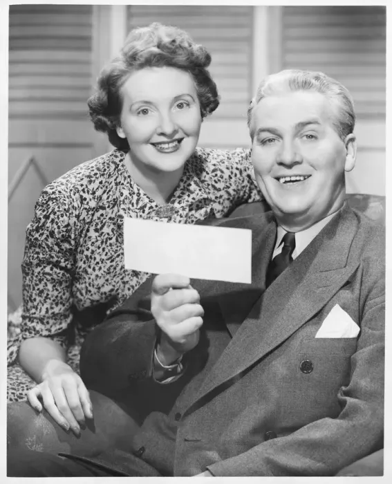 Framed Print : Mature couple posing, man holding check, (B&W), portrait Framed Print : Mature couple posing, man holding check, (B&W), portrait