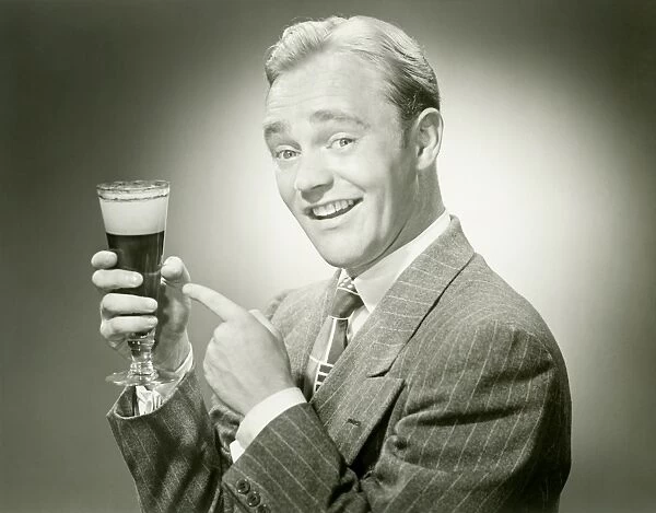 Mature man holding drink, smiling, portrait