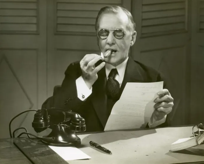 Framed Print : Mature man lights cigar at desk Framed Print : Mature man lights cigar at desk