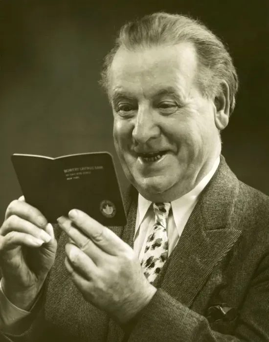 Framed Print : Mature man looking at a bank account booklet