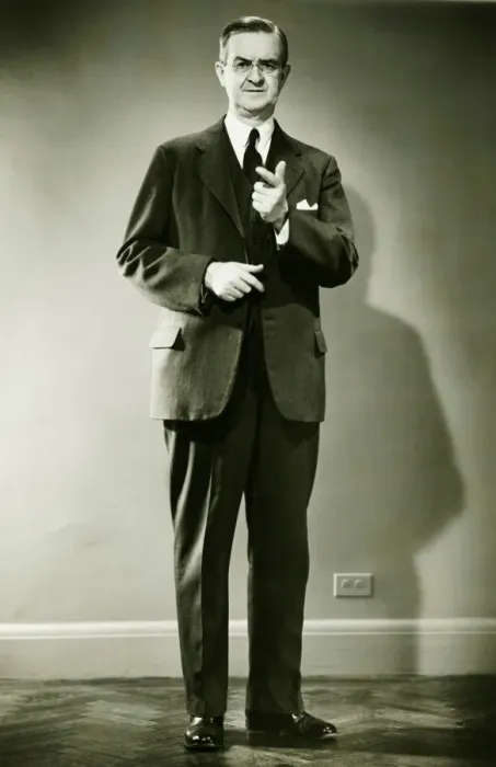 Framed Print : Mature man pointing in studio, (B&W), portrait