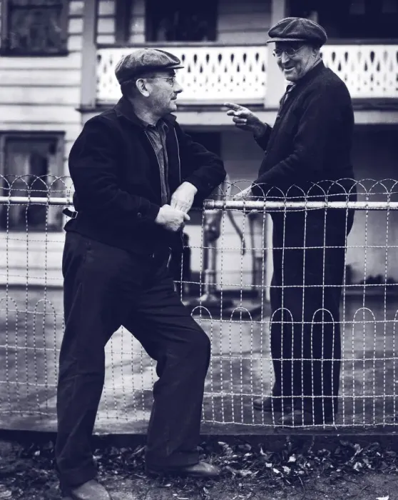 Framed Print : Two mature men talking over fence (B&W) Framed Print : Two mature men talking over fence (B&W)
