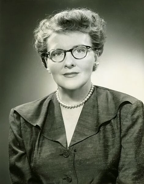 Mature woman in eyewear posing in studio, (B&W), (Close-up), (Portrait)