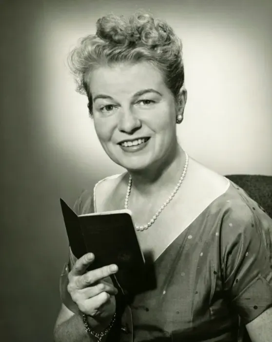 Framed Print : Mature woman holding small book, posing in studio, (B&W), portrait Framed Print : Mature woman holding small book, posing in studio, (B&W), portrait