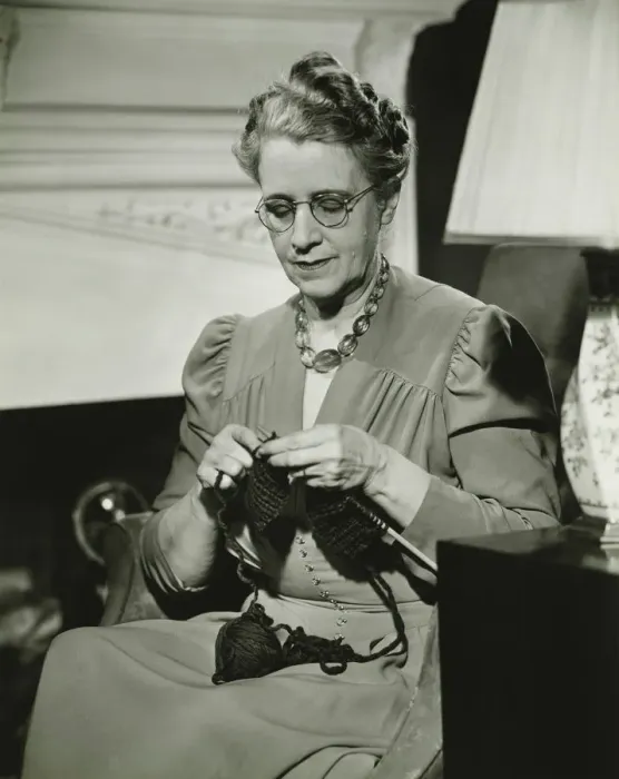 Framed Print : Mature woman knitting in living room, (B&W) Framed Print : Mature woman knitting in living room, (B&W)