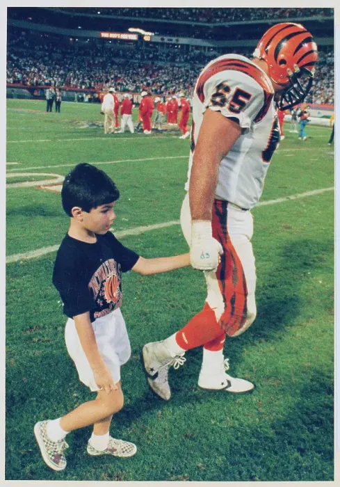 Framed Print : Max Montoya Strolling with His Son Across Football Turf Framed Print : Max Montoya Strolling with His Son Across Football Turf