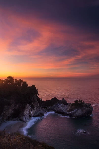 Mcway falls at sunrise over pacific ocean