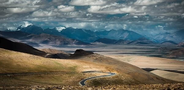 Meandering road over Tibetan hill side