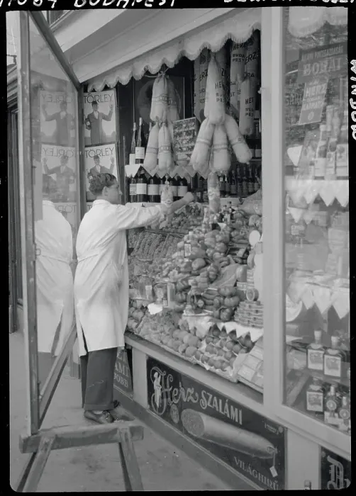 Framed Print : Meat Market Vendor Arranging Window Display Framed Print : Meat Market Vendor Arranging Window Display