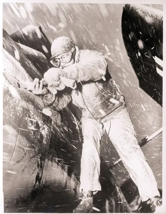 Framed Print : Mechanic Working on Plane in Snowstorm Framed Print : Mechanic Working on Plane in Snowstorm