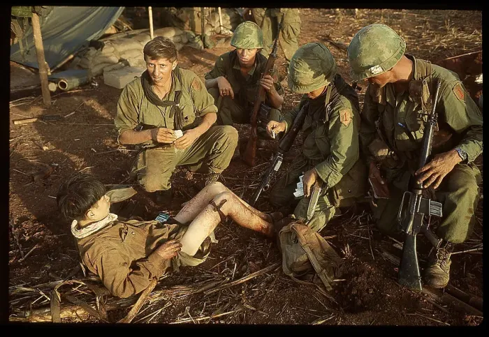 Framed Print : US Medic Dressing Leg of Captured Viet Cong