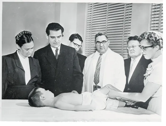 Framed Print : Medical Specialist Observing Young Polio Victim on Table Framed Print : Medical Specialist Observing Young Polio Victim on Table