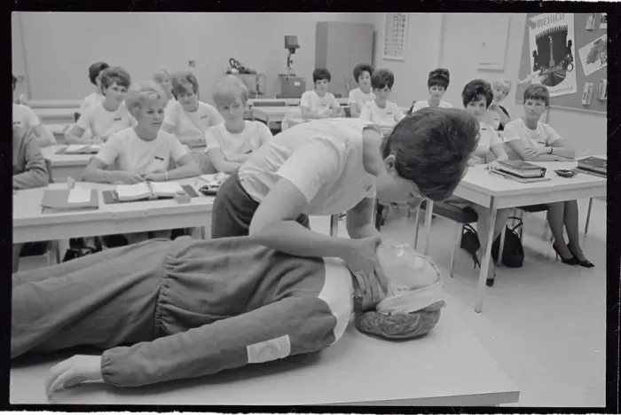 Framed Print : Medical Trainee Bending over Dummy on Table Framed Print : Medical Trainee Bending over Dummy on Table