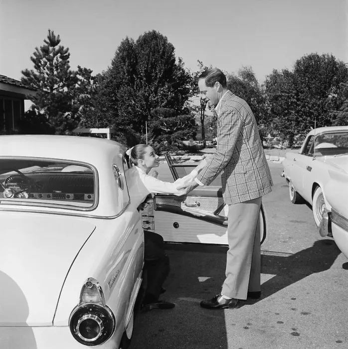 Framed Print : Mel Ferrer Helping Audrey Hepburn Out of Car