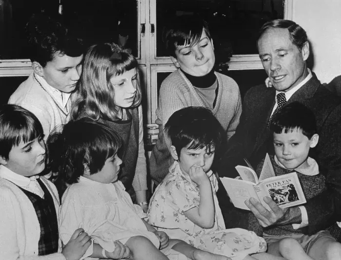 Framed Print : Mel Ferrer Reading to Children