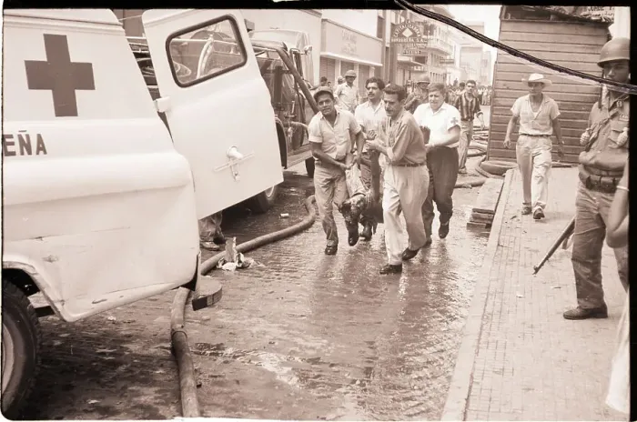 Framed Print : Men Carry Victim to Ambulance on Street Framed Print : Men Carry Victim to Ambulance on Street