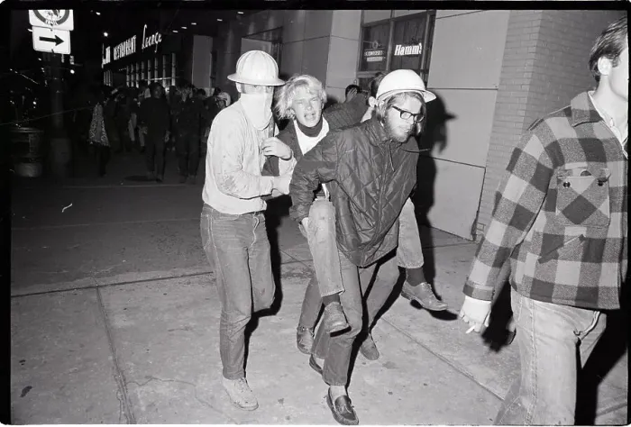 Framed Print : Men Carrying Fellow Protester Framed Print : Men Carrying Fellow Protester