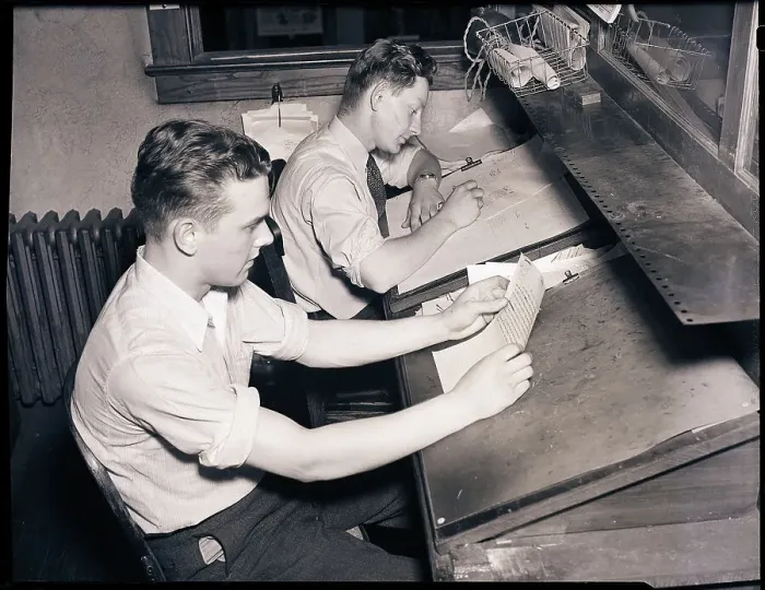 Framed Print : Men At Desks Proofreading Documents