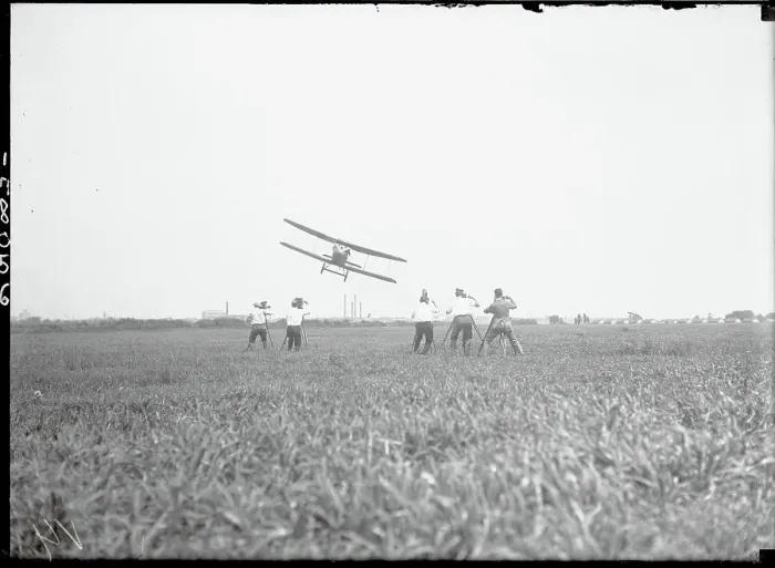 Framed Print : Men Filming Airplane in Flight Framed Print : Men Filming Airplane in Flight