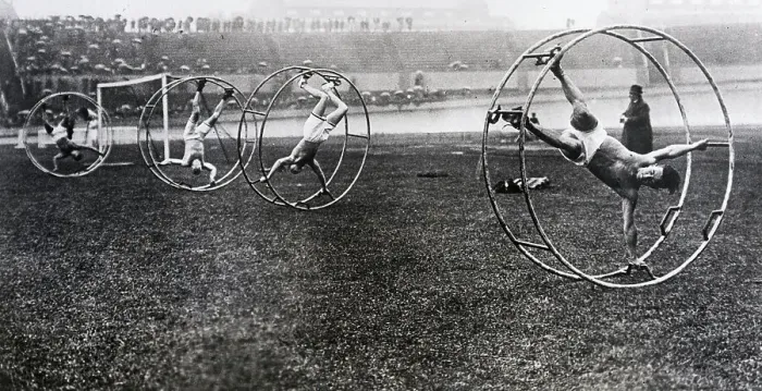 Framed Print : Men Participating in Cat-in-the-Wheel Race Framed Print : Men Participating in Cat-in-the-Wheel Race