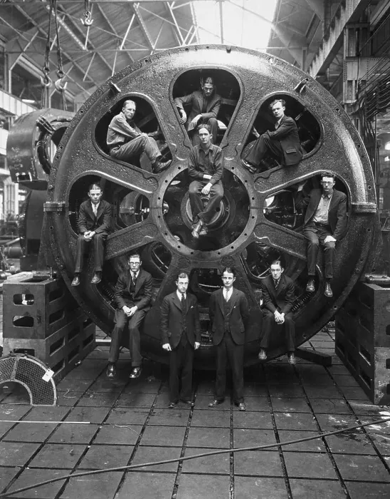 Framed Print : Men Perched Inside Huge Motor Framed Print : Men Perched Inside Huge Motor