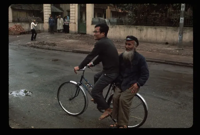 Framed Print : Men Riding a Bike in Street Framed Print : Men Riding a Bike in Street