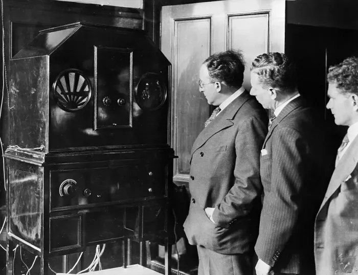 : Men Stand by Machine for Receiving TV : Men Stand by Machine for Receiving TV