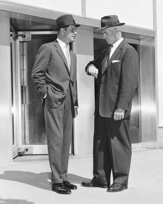 Framed Print : Two men standing, one checking watch Framed Print : Two men standing, one checking watch