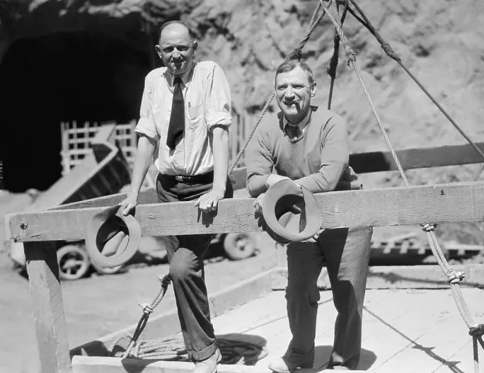 Framed Print : Two Men Standing at Dam Site