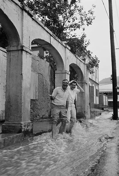 Two men standing in flowing water, smiling