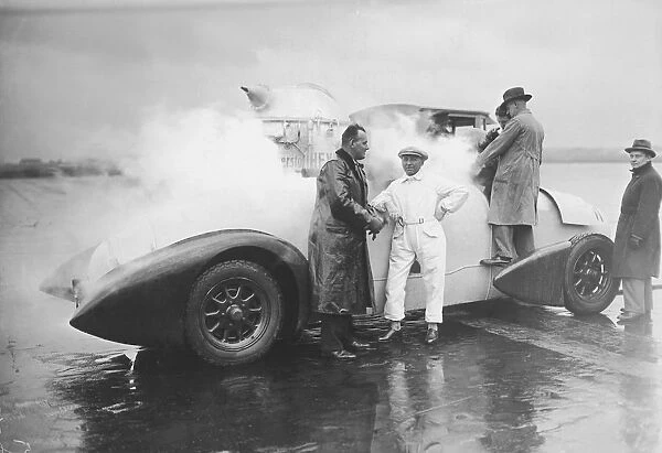Men standing around liquid oxygen propulsion car (B&W)