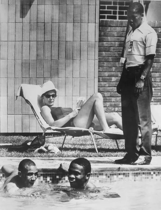 Framed Print : Two Men Swimming in Pool While Others Look On Framed Print : Two Men Swimming in Pool While Others Look On