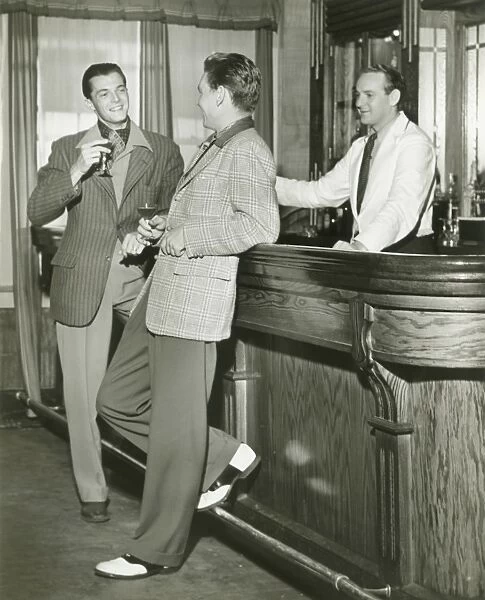 Two men talking at bar counter