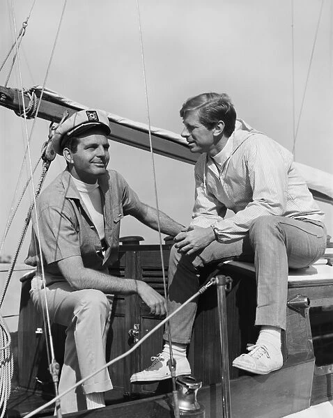 Two men talking in boat, smiling