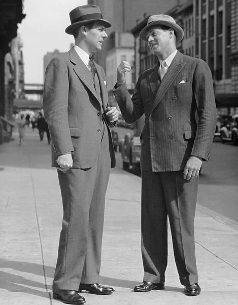 Two men talking on street