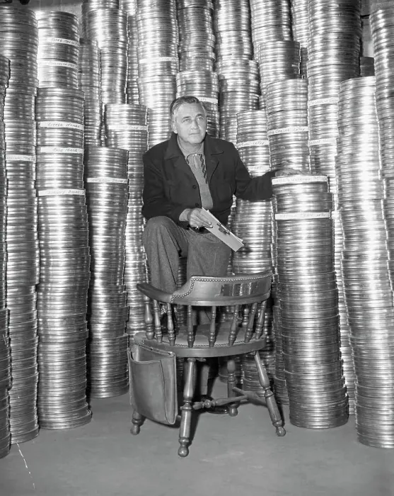 Framed Print : Mervyn LeRoy Posing with Film Reels Framed Print : Mervyn LeRoy Posing with Film Reels