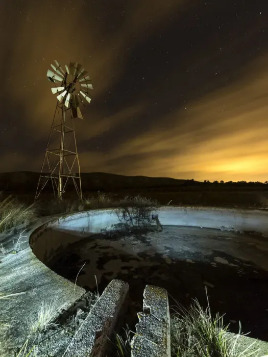 Framed Print : A metal tower windmill at night
