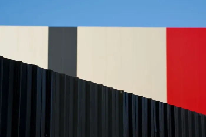 Framed Print : Metallic fence against modern colorful wall Framed Print : Metallic fence against modern colorful wall