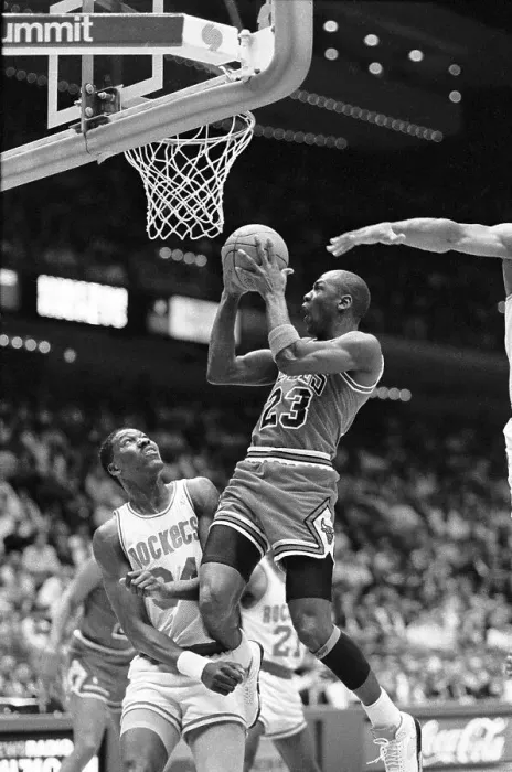 Framed Print : Michael Jordan Jumping Over Akeem Olajuwan to Score Framed Print : Michael Jordan Jumping Over Akeem Olajuwan to Score
