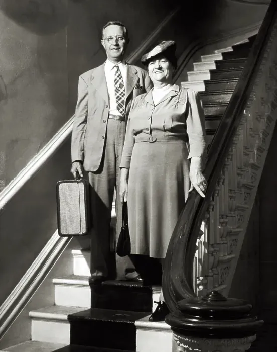 Framed Print : MIDDLE-AGED COUPLE WITH SUITCASE STANDING ON STAIRCASE